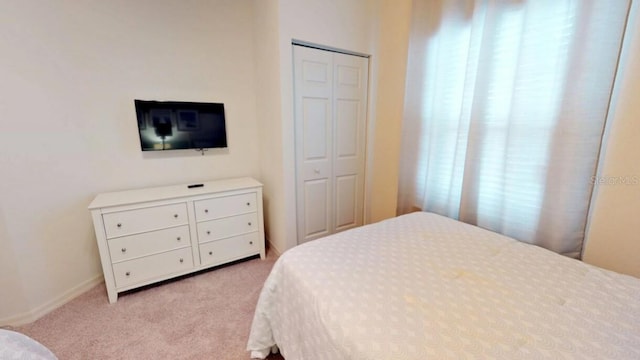 carpeted bedroom with a closet