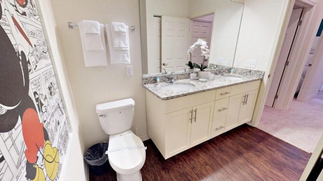 bathroom featuring vanity, hardwood / wood-style flooring, and toilet