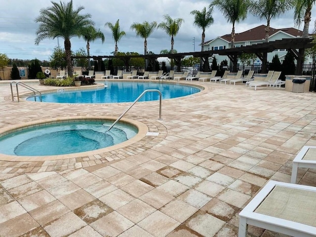 view of pool featuring a pergola, a patio area, and a hot tub