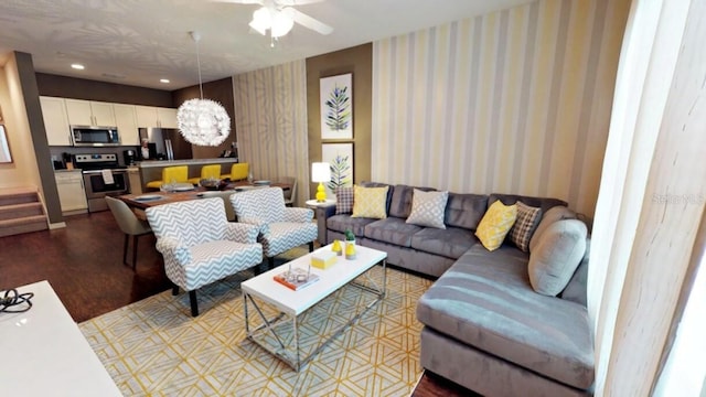 living room featuring ceiling fan and wood-type flooring