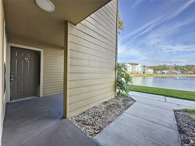 doorway to property with a water view