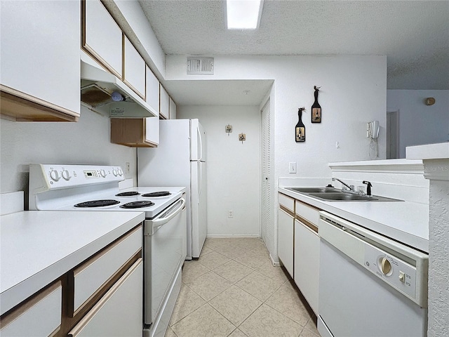 kitchen with white cabinets, a textured ceiling, white appliances, and sink