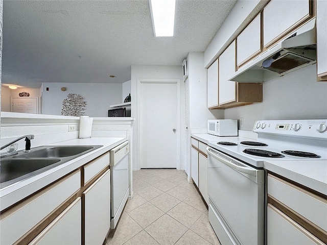 kitchen featuring sink, light tile patterned floors, a textured ceiling, white appliances, and white cabinets