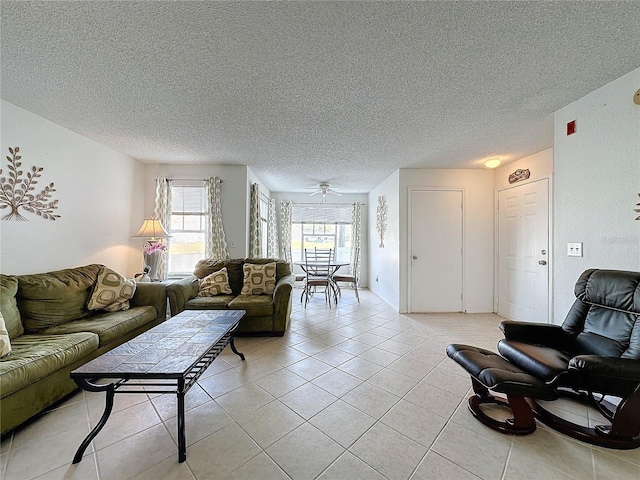 living room with light tile patterned floors, a textured ceiling, and ceiling fan