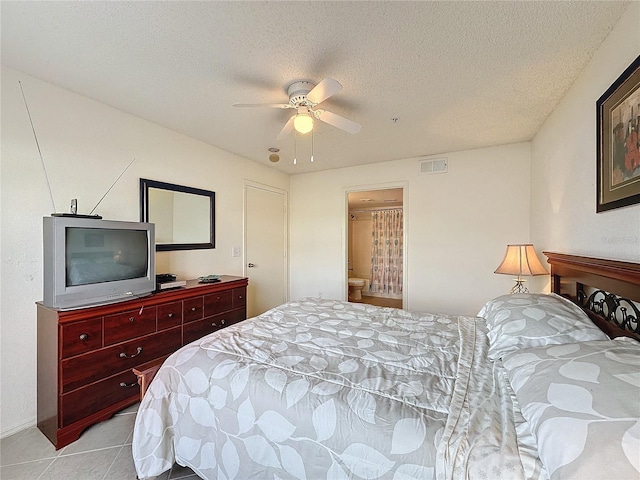 bedroom with ceiling fan and a textured ceiling