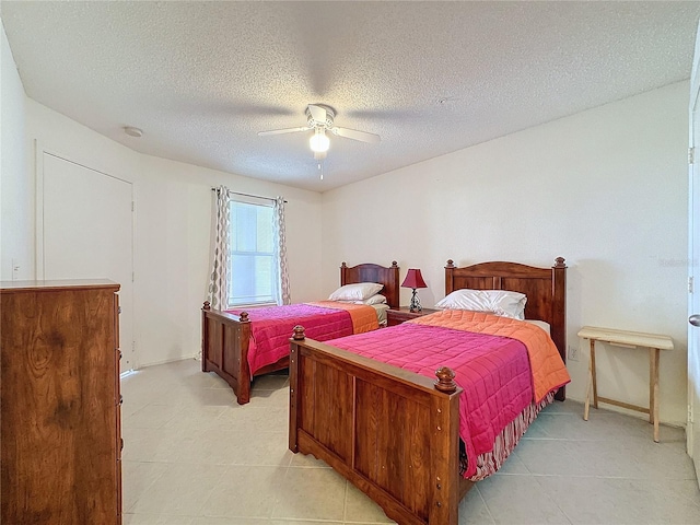 bedroom with a textured ceiling and ceiling fan