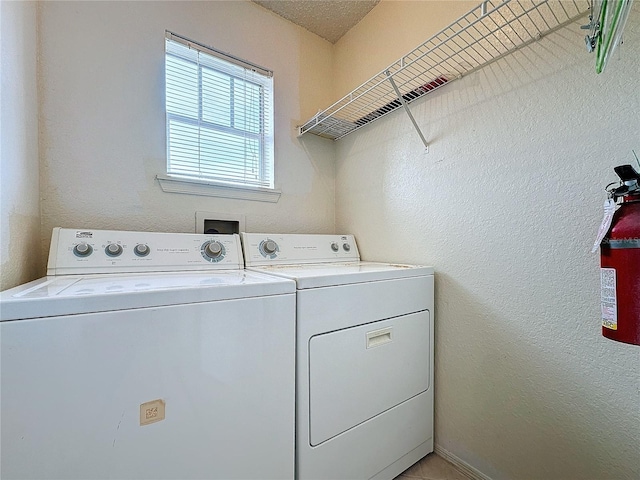 clothes washing area featuring washing machine and clothes dryer