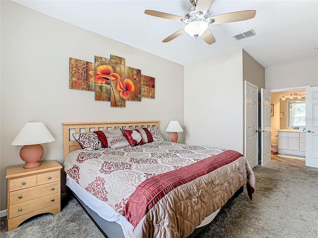 carpeted bedroom featuring ensuite bathroom and ceiling fan