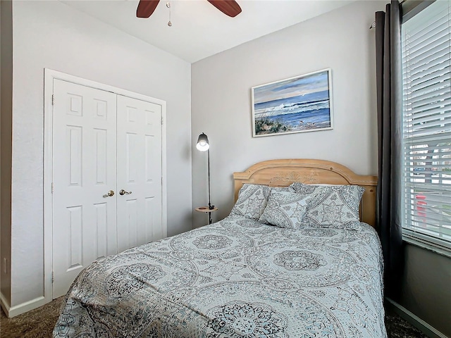 carpeted bedroom featuring ceiling fan and a closet