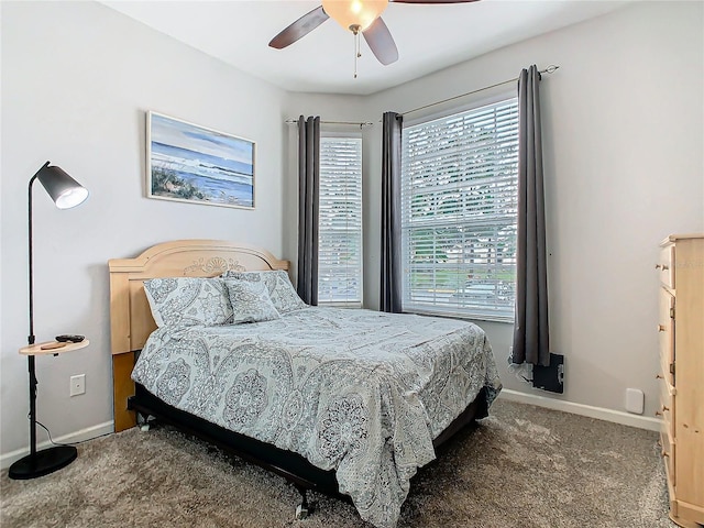 carpeted bedroom with multiple windows and ceiling fan