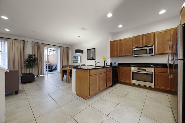 kitchen with kitchen peninsula, appliances with stainless steel finishes, sink, decorative light fixtures, and light tile patterned flooring