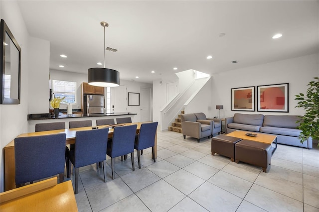 dining space featuring light tile patterned flooring