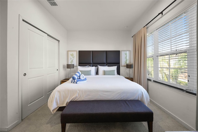 carpeted bedroom with a closet