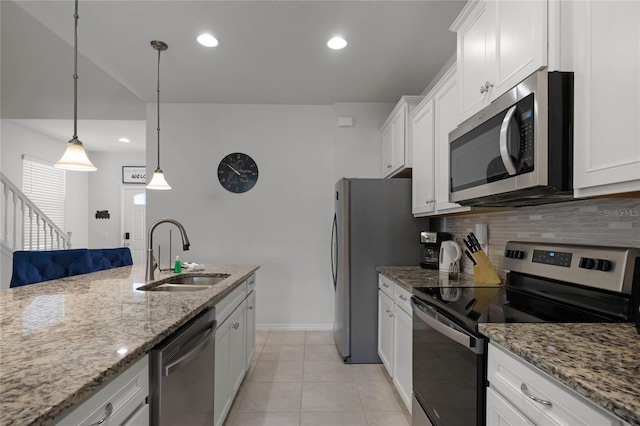 kitchen featuring white cabinets, decorative light fixtures, sink, and stainless steel appliances