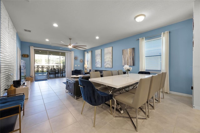 tiled dining area featuring ceiling fan