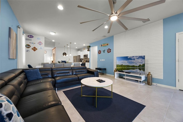 tiled living room with ceiling fan