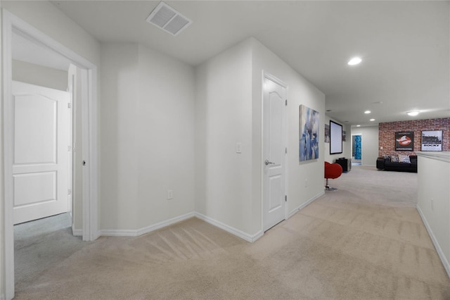 hallway featuring light colored carpet