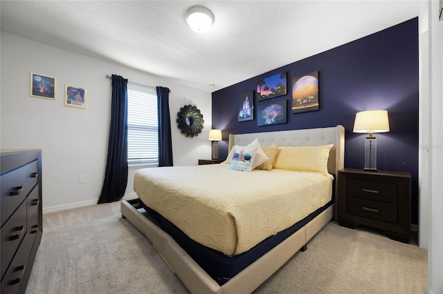 carpeted bedroom featuring a textured ceiling