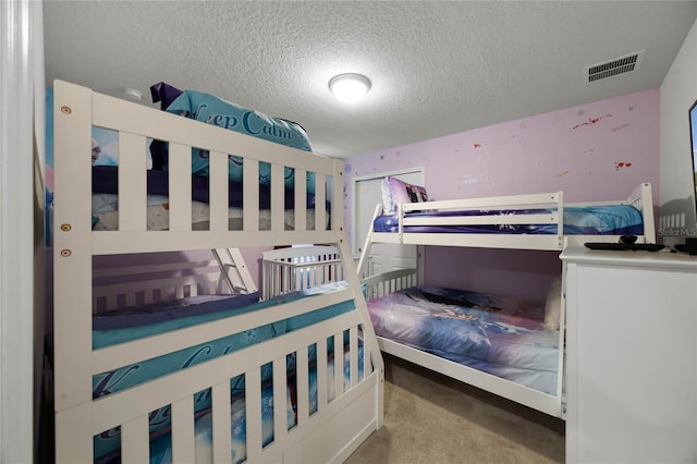 carpeted bedroom with a textured ceiling