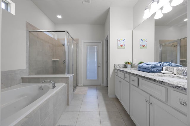 bathroom with tile patterned flooring, vanity, and independent shower and bath