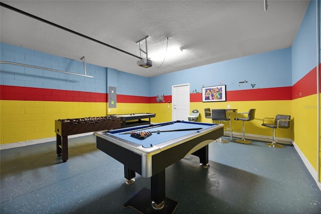 game room with electric panel, a textured ceiling, and billiards