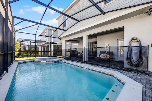 view of pool with a lanai, an in ground hot tub, and a patio