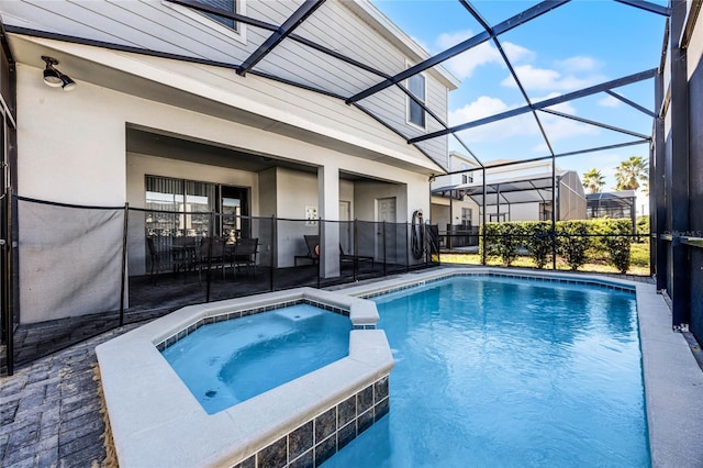 view of pool with a patio area, a lanai, and an in ground hot tub