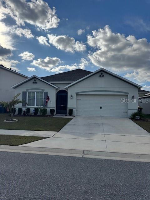 single story home with a garage and a front yard