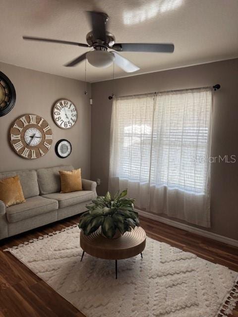 unfurnished living room with dark wood-type flooring and ceiling fan