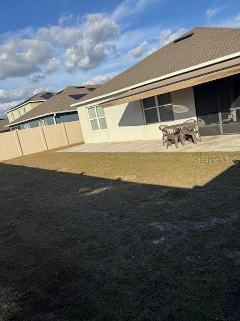 back of property with a patio