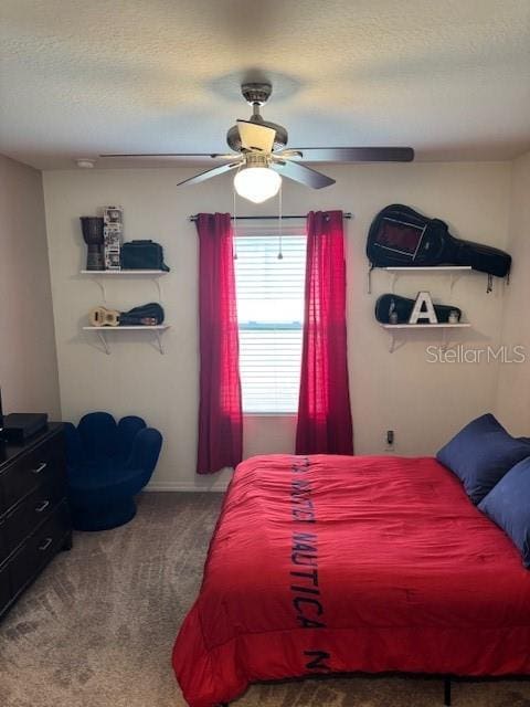 carpeted bedroom with ceiling fan and a textured ceiling