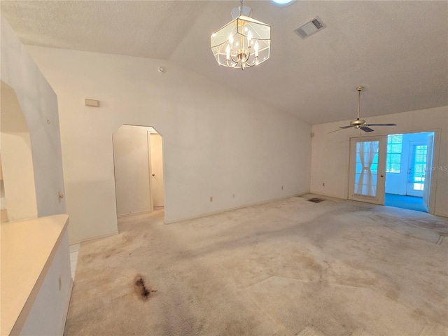 unfurnished living room featuring light carpet, french doors, ceiling fan with notable chandelier, and lofted ceiling