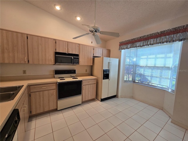 kitchen featuring ceiling fan, sink, a textured ceiling, vaulted ceiling, and black appliances