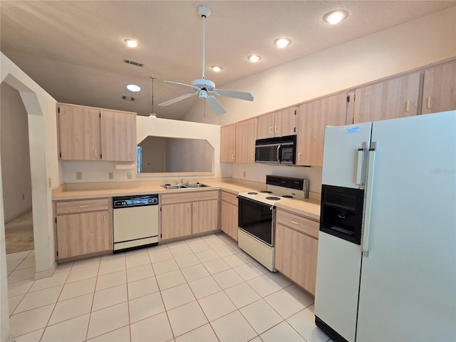 kitchen with light brown cabinets, white appliances, ceiling fan, and sink