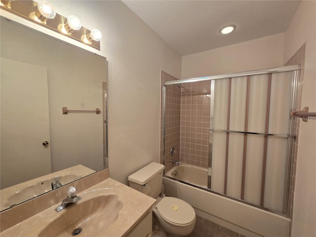 full bathroom featuring tile patterned floors, vanity, toilet, and shower / bath combination with glass door