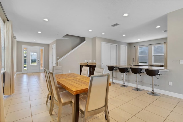 tiled dining room featuring sink