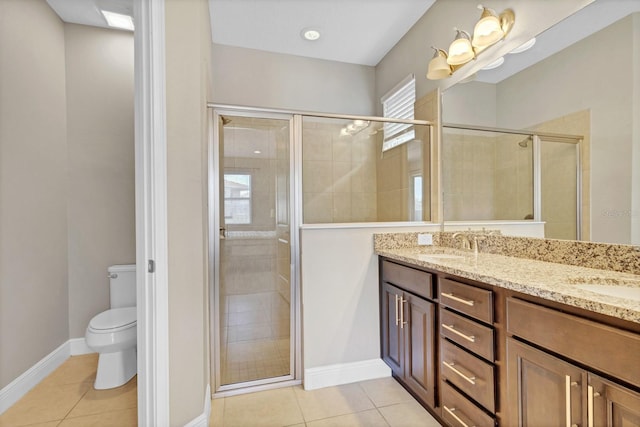 bathroom featuring toilet, a shower with door, tile patterned floors, and vanity