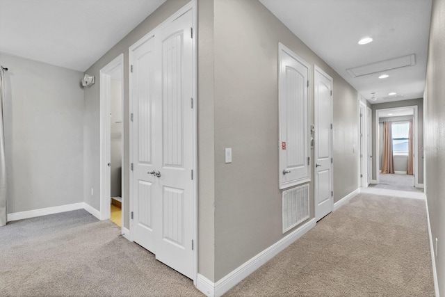 hallway with light colored carpet