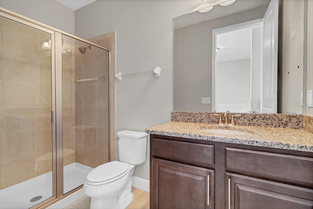 bathroom with walk in shower, vanity, and toilet