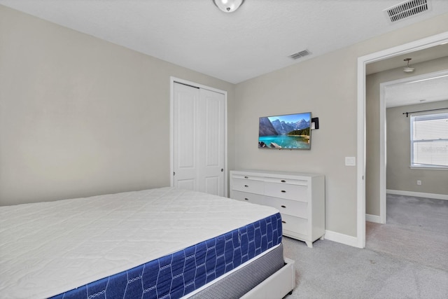 carpeted bedroom featuring a closet