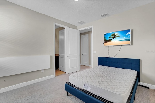 carpeted bedroom with a textured ceiling