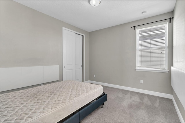 carpeted bedroom featuring a closet