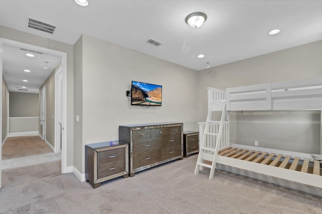 carpeted bedroom with a textured ceiling