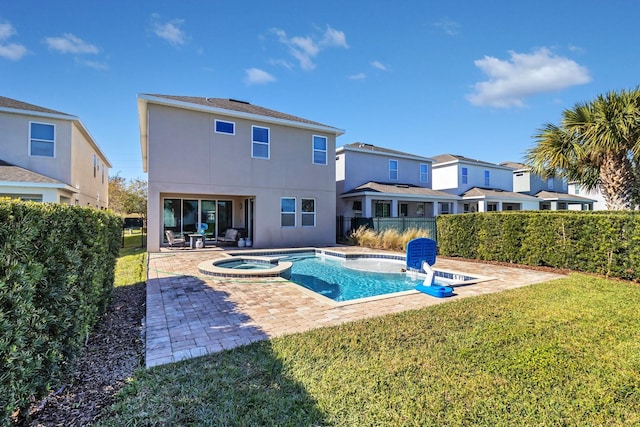 view of pool with a patio, a yard, and an in ground hot tub