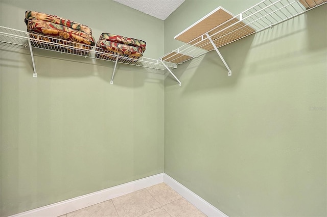 walk in closet featuring tile patterned flooring