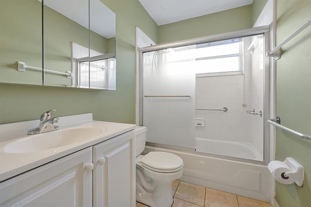 full bathroom featuring toilet, tile patterned floors, vanity, and shower / bath combination with glass door