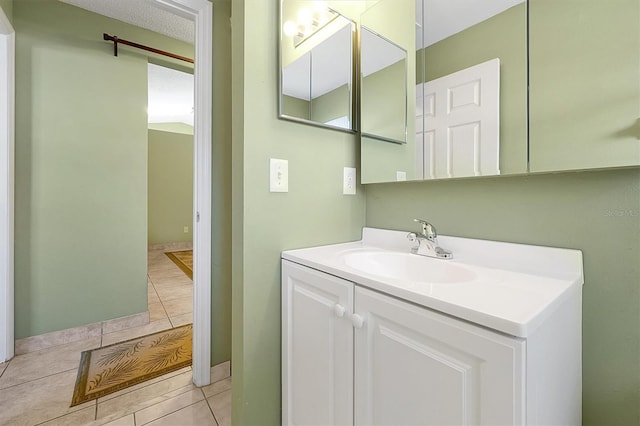 bathroom featuring vanity, tile patterned floors, and a textured ceiling