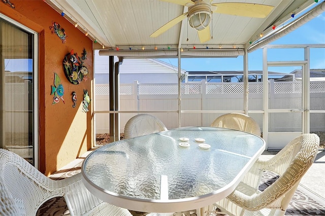 sunroom featuring ceiling fan