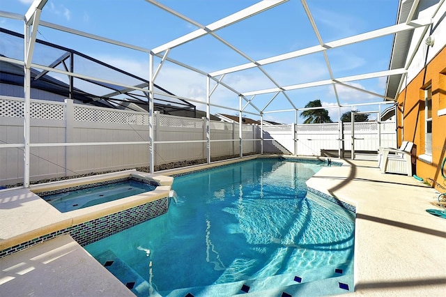 view of swimming pool with an in ground hot tub, a patio area, and a lanai