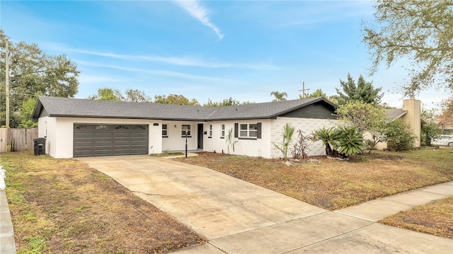 ranch-style home with a garage and a front lawn